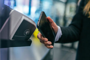 A person using their smartphone to make an NFC-enabled payment.